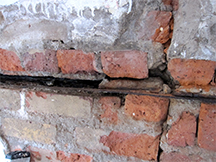 Rusting of steel beam in brickwork.